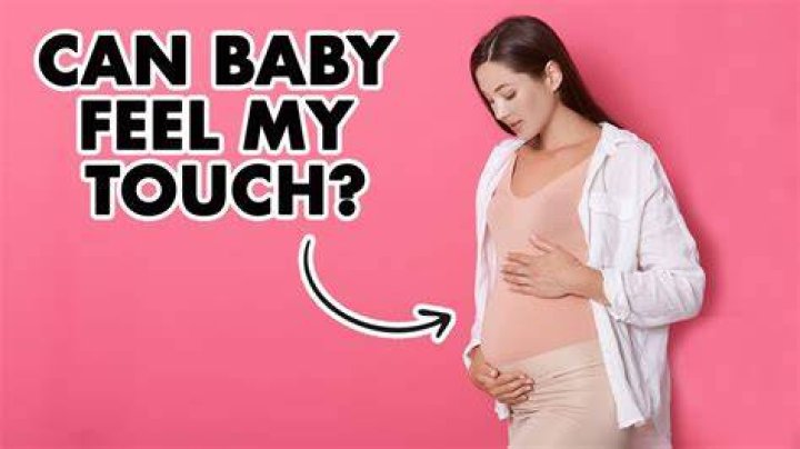 When can my baby feel me rub my belly?