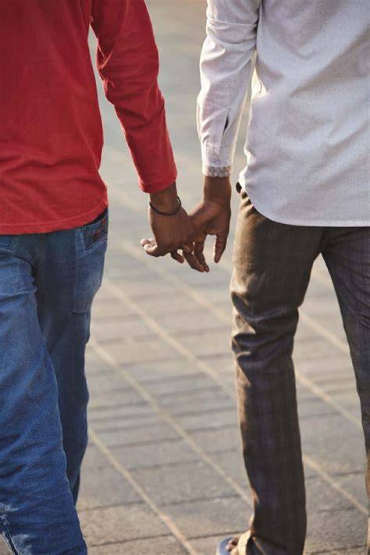 Why do men hold hands in Asia?